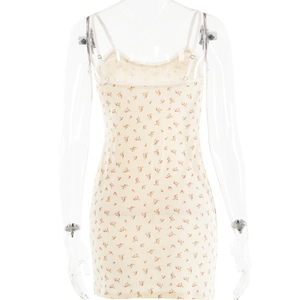 Close-up of beige cotton mini dress featuring red floral patterns and lace V-neck detail