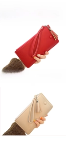 Detailed view of red and beige pebbled leather long wallets with tassels and wrist straps