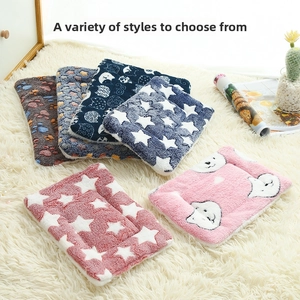 Close-up of soft plush pet mats with various patterns like stars and animal prints
