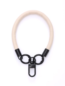 Detail view of the beige leather phone wrist strap with black metal swivel clasp