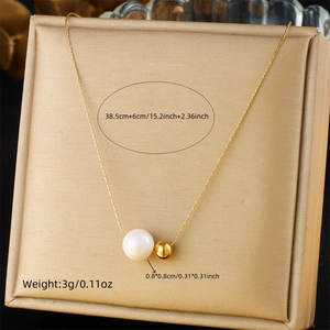 Detail view of gold chain necklace with white pearl and golden bead including measurements