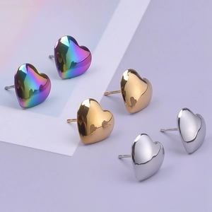 Three pairs of heart-shaped stainless steel earrings in silver gold and rainbow finishes