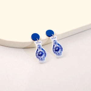 Detail of elegant blue and white porcelain pattern drop earrings with acrylic finish