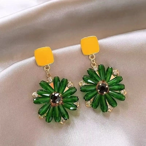 Detail of floral earrings with yellow square studs and green crystal glass petal tassels