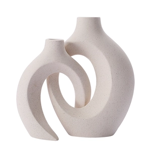 Minimalist white ceramic interlocking vases with subtle speckled matte finish