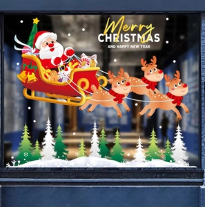 Detail of Christmas window stickers featuring Santa on a sleigh with reindeer and forest