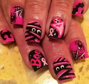 Detail of pink and black Halloween press-on nails with ghost, mummy and spiderweb patterns