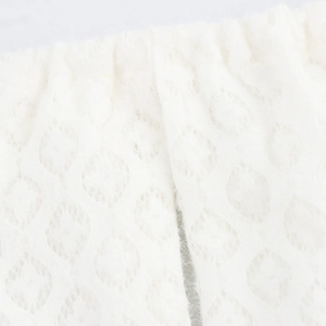 White halter neck backless knitted dress featuring a soft textured diamond lace pattern