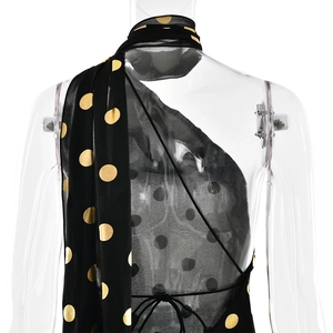 Dettaglio dell'abito in chiffon a pois con schiena scoperta e sottili spalline incrociate
