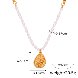 Detail showing freshwater pearls and gold-plated teardrop pendant with wheat relief