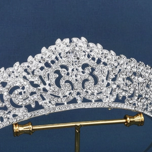 Elegant silver bridal crown with intricate floral crystal patterns on a metal base