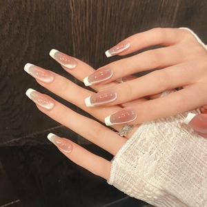 Detail of long coffin nails with nude pink cat eye base and white French tips
