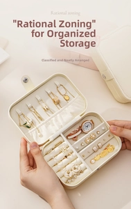 Detail of travel jewelry box showing necklaces hooks and ring slots in beige PU leather