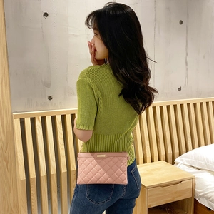 Fashionable pink quilted crossbody bag with gold chain strap and elegant metallic detail