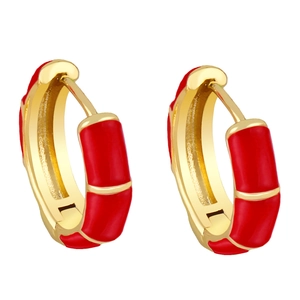 Detail of red enamel bamboo hoop earrings with polished golden metallic finish