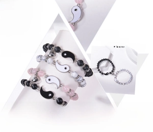 Detail showing magnetic heart clasp and Tai Chi pendants on natural stone bracelets