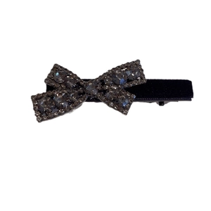 Elegant black velvet bow hair clip with dark gray rhinestones on a white background