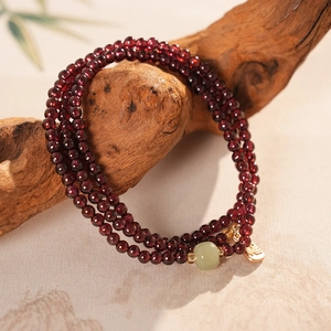 Deep red garnet bead bracelet with jade and lucky gold pendant in Neo-Chinese style