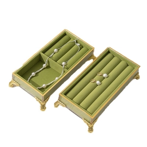 Green velvet jewelry box with gold metal legs for necklaces and earrings storage