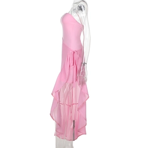 Side view of pink strapless dress featuring ruffled hem and high-low asymmetric slit cut