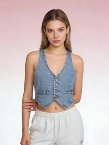 Detail of slim fit light blue denim vest showing metal buttons and V-neckline texture