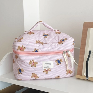 Detail of pink striped bear makeup bag featuring quilted cotton fabric and zip handle
