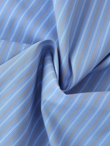 Close-up of the light blue striped textile fabric with soft drapery and fine weave detail