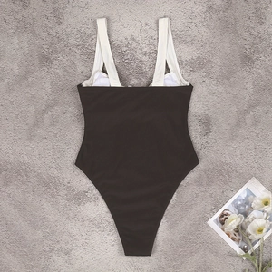 Sleek one-piece swimsuit in black and white contrast with high-cut leg and wide straps