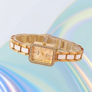 Close-up of square dial with rhinestones and white ceramic gold metal strap watch