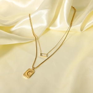 Double-layered gold stainless steel necklace with sun moon and zircon pendants on silk