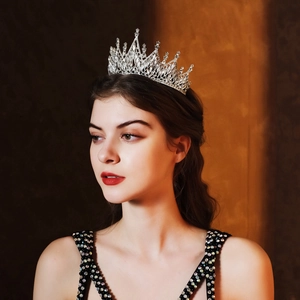 Close-up of a luxury silver bridal crown with sparkling crystals on a brunette model