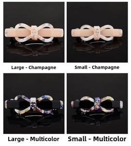 Detail view of large and small acetate bow hair clips in champagne and marble colors