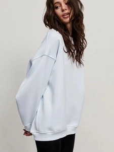 Detailed view of light blue oversized sweatshirt with drop shoulder and ribbed cuff