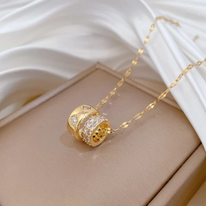 Golden titanium steel necklace with double ring pavé diamond pendants on white silk