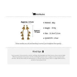 Detail view showing dimensions of vintage gold tassel earrings with alloy material specs