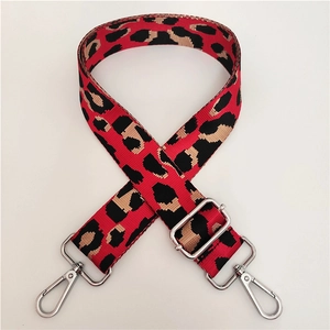 Detail of adjustable leopard print bag strap with silver metal swivel hooks and buckles
