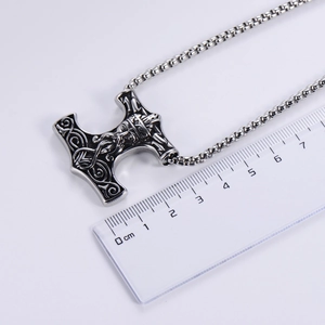 Vintage Viking Thor's Hammer stainless steel pendant measured by a ruler on white background