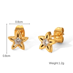 Detailed macro view of 0.8cm golden star stud earrings with central cubic zirconia inlay