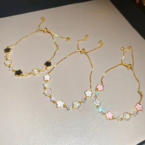 Elegant gold flower bracelets with colorful acetate petals and sparkling zircons