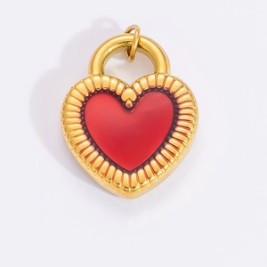Macro shot of 18k gold heart pendant with red center and radiating texture detail