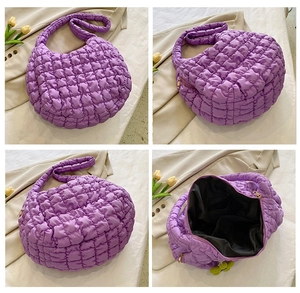 Detail view of purple quilted puffer bag with soft cloud texture and glossy fabric