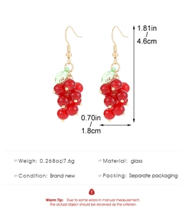 Detailed size view of red resin raspberry drop earrings with gold hooks and green leaf