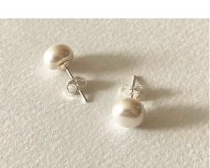 Detailed close-up of natural baroque freshwater pearls on 925 sterling silver studs