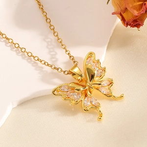 Detailed close-up of a gold bow pendant with sparkling crystals on white satin