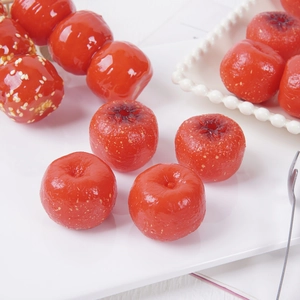 Realistic PVC hawthorn models with glossy sugar syrup coating and sesame seeds on white plates