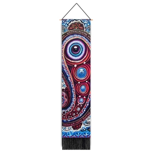 Detail of bohemian wall hanging featuring mandala eye and Om Mani Padme Hum text design