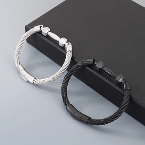 Detailed macro view of barbell dumbbells on woven stainless steel wire bracelets in silver and black