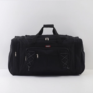 Close-up of black travel bag with HEIOU logo, front zipper pockets and reinforced handles