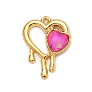 Detailed view of heart-shaped gold pendant with pink crystal and liquid metal design