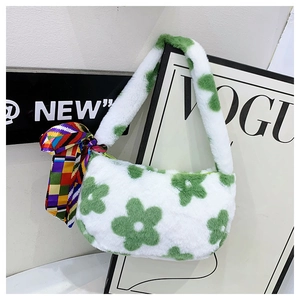Macro shot of fluffy white plush handbag with green flower patterns and colorful silk scarf